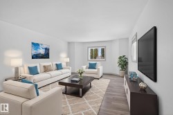 Spacious living area featuring light wood-finish flooring and neutral wall tones - 