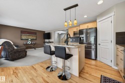 Kitchen island with stone-finish countertop and breakfast bar seating - 
