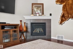 Fireplace featuring a tiled surround and white mantel - 