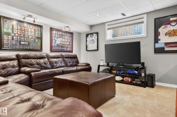 Finished basement area with neutral carpeting and light gray walls - 