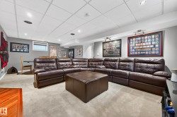 Carpeted recreation room featuring recessed lighting, a drop ceiling, and a high-set window - 