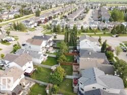 Aerial perspective showcasing a residential neighborhood with numerous detached homes - 