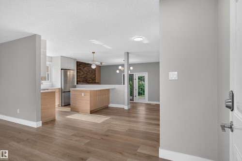 Contemporary kitchen and living area featuring wood-finish flooring - 33 Brookside Avenue, Spruce Grove, AB 