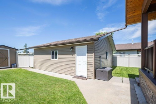 Detached garage with horizontal siding, white door, and windows - 10420 111 Avenue, Westlock, AB 