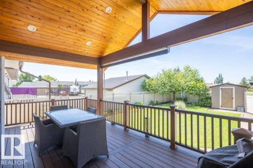 Covered outdoor deck with wood-finish ceiling, recessed lighting, and durable composite decking - 10420 111 Avenue, Westlock, AB 