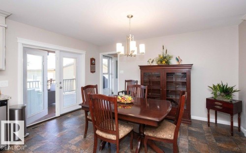 Dining area featuring neutral wall tones and patterned tile flooring - 10420 111 Avenue, Westlock, AB 