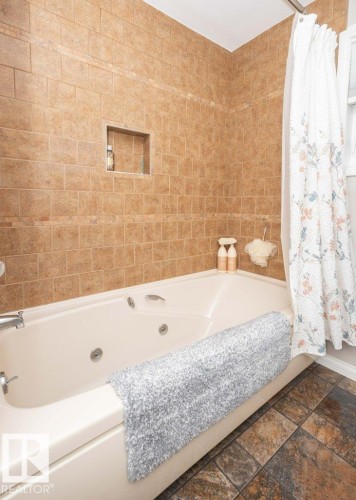 Soaking tub featuring multiple jets and chrome fixtures - 10420 111 Avenue, Westlock, AB 