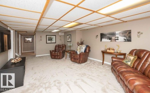 Spacious room with light-toned carpet flooring and neutral wall paint - 10420 111 Avenue, Westlock, AB 