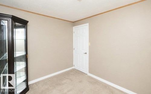 Neutral-toned wall with white trim and a white paneled door - 10420 111 Avenue, Westlock, AB 