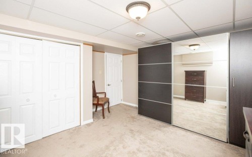 Neutral-toned carpeting paired with light beige walls - 10420 111 Avenue, Westlock, AB 