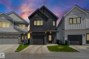 Contemporary exterior featuring dark vertical siding and a prominent gable roofline - 16 19904 31 Avenue, Edmonton, AB 