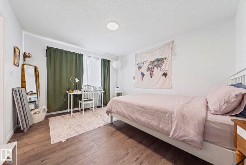 Room featuring wood-finish flooring, white walls, and a recessed ceiling light - 16 19904 31 Avenue, Edmonton, AB 