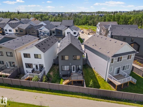 Residential street featuring a collection of two-story homes with dark shingle roofs - 16 19904 31 Avenue, Edmonton, AB 
