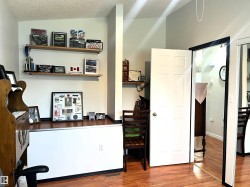 Rich wood-finish flooring complements the neutral wall color in this versatile interior space - 