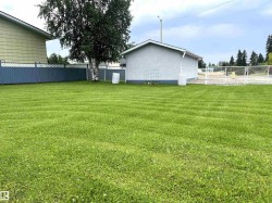 Expansive green lawn with striped cutting pattern - 