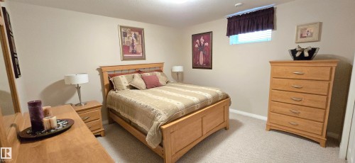 Carpeted room featuring a window with blinds, recessed lighting, and neutral wall tones - 4221 46 Street, Vegreville, AB 