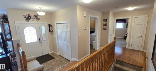 Entryway featuring decorative glass paneled door, sidelight, and ceramic tile flooring - 4221 46 Street, Vegreville, AB 