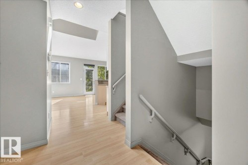 Interior entry hall with light wood-finish flooring - 20 4821 Terwillegar Common, Edmonton, AB 
