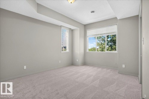 Spacious room featuring light gray walls and plush carpet flooring - 20 4821 Terwillegar Common, Edmonton, AB 