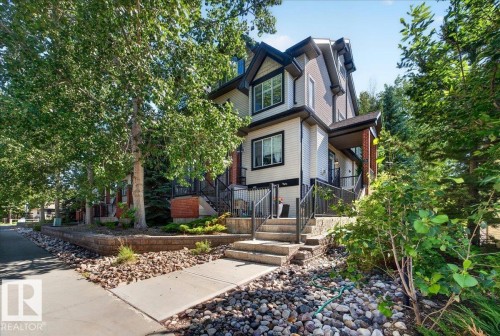 Multi-level residence featuring a light-toned siding exterior with dark trim accents - 20 4821 Terwillegar Common, Edmonton, AB 
