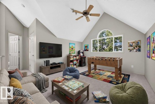 Vaulted ceiling room with an arched window and a ceiling fan - 20 4821 Terwillegar Common, Edmonton, AB 