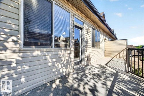 Exterior balcony featuring a concrete surface, black metal railings, and a privacy wall - 20 4821 Terwillegar Common, Edmonton, AB 