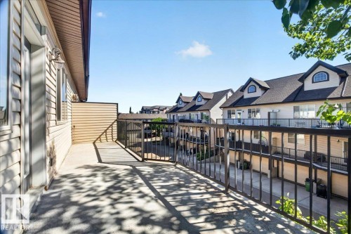 Spacious private balcony with textured concrete flooring and dark metal railings - 20 4821 Terwillegar Common, Edmonton, AB 