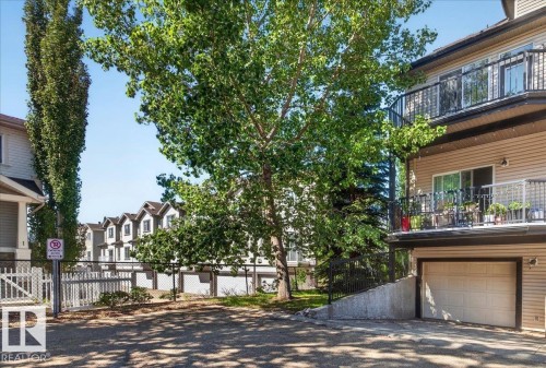 Exterior featuring a beige siding facade and two levels of private balconies with black wrought iron railings - 20 4821 Terwillegar Common, Edmonton, AB 