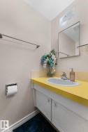 White vanity with two cabinet doors, a yellow countertop, and an integrated basin sink - 