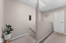 Carpeted interior landing featuring light-toned walls and white trim - 