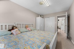 Bedroom featuring neutral wall paint and light carpet flooring - 