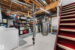 Utility space featuring exposed ceiling joists, a water heater, and a laundry appliance - 