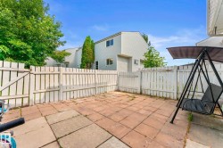 Fenced patio area featuring stone paver flooring - 