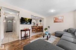 Open concept living area featuring wood-finish flooring - 