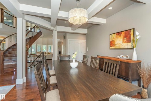 Dining area featuring a coffered ceiling, wood-finish flooring, and a crystal chandelier - 3503 Watson Point(E), Edmonton, AB 
