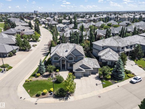 Spacious residential property featuring a stone and siding exterior, multi-car garage, and a gabled roofline - 3503 Watson Point(E), Edmonton, AB 