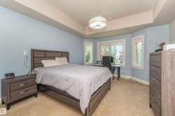 Bedroom featuring a bay window with multiple panes, light blue wall paint, and recessed lighting - 