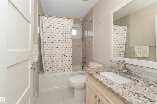 Bathroom featuring a vanity with a granite countertop, undermount sink, and chrome faucet - 3503 Watson Point(E), Edmonton, AB 