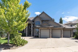 Contemporary-style residence featuring a multi-gabled roofline and stone and stucco exterior - 