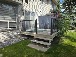 Outdoor deck featuring black metal railings and privacy screen - 