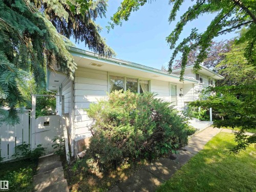White siding exterior with mature landscaping - 5012 143 Street, Edmonton, AB 