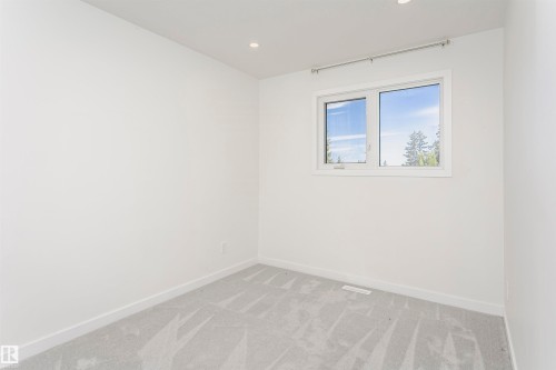 Light-filled room featuring a single window, recessed lighting, white walls, white trim, and gray carpeting - 17716 84 Avenue, Edmonton, AB 