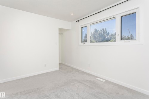 Bright room featuring light gray carpet, white walls, and white trim - 17716 84 Avenue, Edmonton, AB 