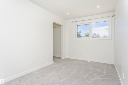 Neutral-toned room with light gray carpeting and white walls - 17716 84 Avenue, Edmonton, AB 