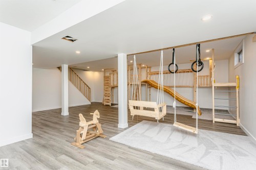 Spacious lower level featuring wood-finish flooring and recessed lighting - 17716 84 Avenue, Edmonton, AB 