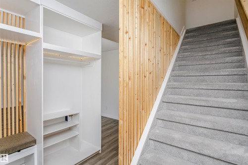 Entryway featuring a built-in storage unit with shelving, a hanging rod, and integrated lighting - 17716 84 Avenue, Edmonton, AB 