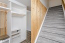 Entryway featuring a built-in storage unit with shelving, a hanging rod, and integrated lighting - 17716 84 Avenue, Edmonton, AB 