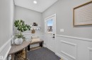 Entryway featuring paneled wainscoting, light wood-finish flooring, and a white front door with a clear glass insert - 1573 Esaiw Place, Edmonton, AB 