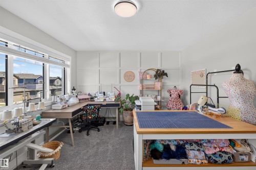 Carpeted room with multiple windows providing natural light - 1573 Esaiw Place, Edmonton, AB 