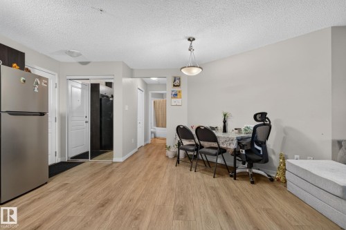 Open-concept living space with wood-finish flooring - 140 301 Clareview Station Drive, Edmonton, AB 